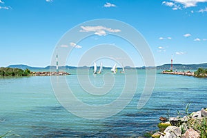 Sailboats sail along the piers of Balatonlelle at Lake Balaton