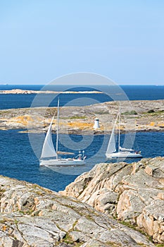 Sailboats sailing in rocky archipelago