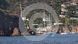 Sailboats and sailing yachts moored in bay of Mediterranean sea. Lipari Islands, Sicily, Italy
