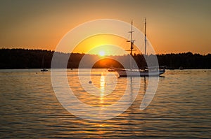 Sailboats Silhouetted Against Sunrise