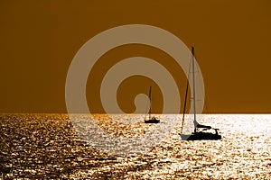 Sailboats silhouettes at dusk