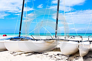 Sailboats on tropical beach during summer day with turquoise water and blue sky. Varadero resort, Cuba. Vacation background