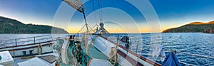 Sailing along beautiful islands scenario. Panoramic seascape sunset view from the sailing ship