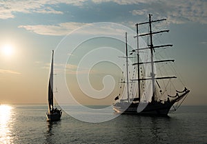 Sailing boat achored on Tallinn bay. 3 mast sailing yacht enjoying the sunset on calm Baltic sea. Beautiful weather and