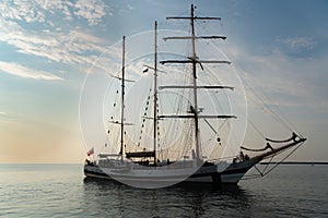Sailing boat achored on Tallinn bay. 3 mast sailing yacht enjoying the sunset on calm Baltic sea. Beautiful weather and