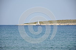 Sailing boat on Adriatic Sea defront isolated island