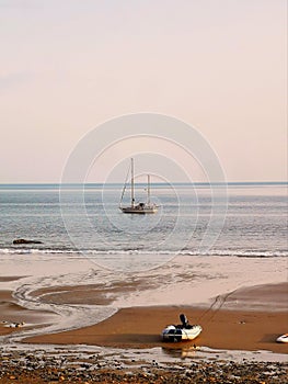 Sailing boat at anchor near beach