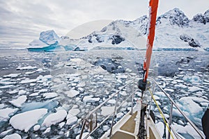 Sailing boat in Antarctica, yacht navigation in ice