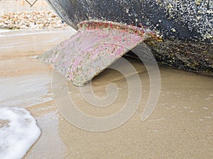 Sailing boat on the beach leans on the keel photo