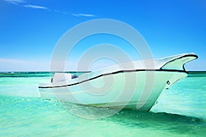 Sailing boat in the blue carribean sea and beautiful cloudscape