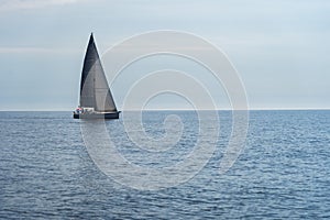 Sailing boat on blue open sea. Concept of Dream, adventure and freedom