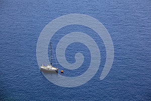 Sailing boat in blue sea, aerial view.