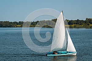 Sailing boat on a calm lake