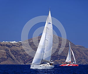 Sailing boat and catamaran in Santorini photo