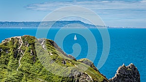 A yacht from cliff at durdle door, Dorset, Jurassic coast, England