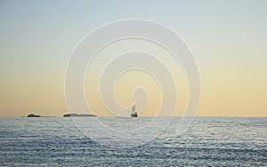 Sailing boat converted to an old sailing pirate ship in the Mediterranean Sea at sunrise, Cirali, Turkey