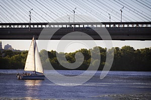 A sailing boat floats under the southern bridge in Kiev