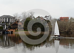 Sailing boat `Laser` in the Nut Bay of Moscow Region in early spring