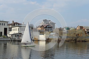 Sailing boat `Laser` in the Nut Bay of Moscow Region in early spring