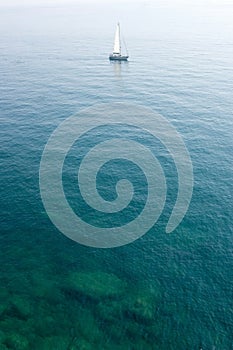 Sailing boat in limpid water photo