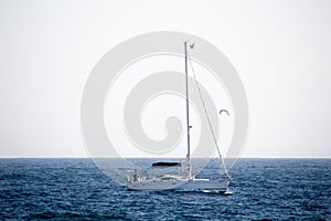 A sailing boat in a mediterranean blue sea.