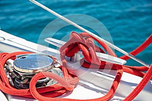 Sailing boat mooring rope tied on cleat. Heavy metal chain around the winch