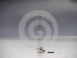 Sailing boat near coastline of Jan Mayen island