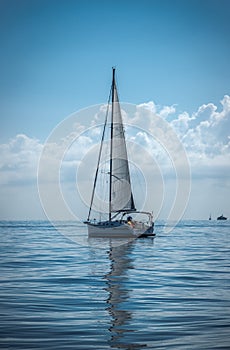 Sailing boat on the ocean during a calm summer day
