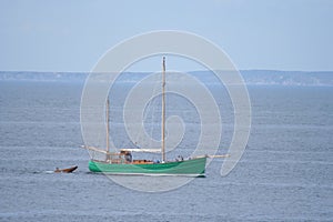 Sailing boat pulling dingy