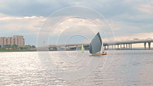 sailing boat sails on the river in the city.Dynamic movement on water.