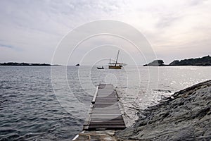 Sailing boat at sea with horizon line in the background photo