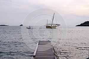 Sailing boat at sea with horizon line in the background photo
