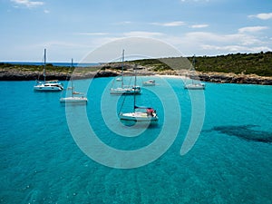 Sailing boat ship yacht anchored on turquoise blue water Cala Varques bay mediterranean sea Mallorca Balearic Spain