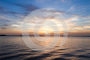 Sailing boat silhouette over sunset sky