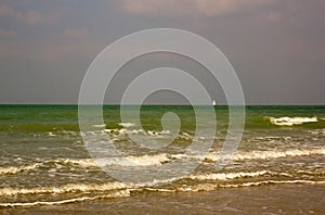 Sailing boat, small point on the vastness. Dieppe, Seine-Maritime, France.