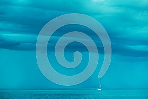 Sailing boat at stormy sea horizon