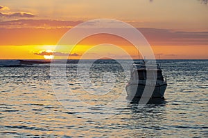 Sailing boat during sunset on the public beach of Albion,Mauritius.