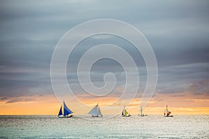 Sailing boat to the sunset in Boracay island on Philippines