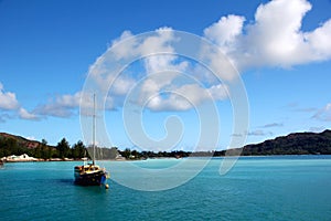 Sailing boat in turquoise blue water in the Seychelles