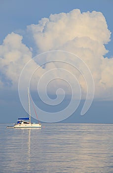 Sailing boat and white cloud and quiet sea