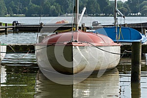 Sailing boat at a wooden pier on a lake