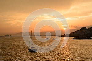 Sailing boat yacht at sunset in Roses Bay at Costa Brava, Catalonia