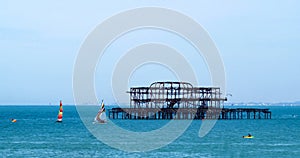 Sailing boats around the derelict West pier in Brighton