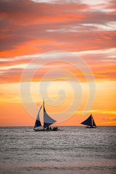 Sailing boats with a beautiful sunset at the sea