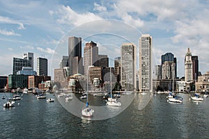 Sailing boats on the Charles River in front of Boston Skyline in Massachusetts USA on a sunny summer day