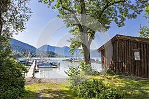 Sailing boats on a jetty at lake Tegernsee, Bavaria, Germany