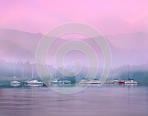 Sailing boats on lake Ullswater at dawn