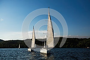 Sailing boats participate in yachting regatta in the Aegean Sea.