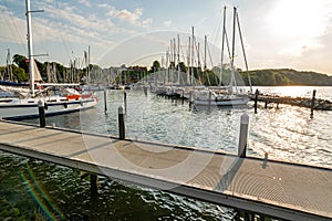 Sailing boats and pier in a marina (Langballigau) during sunset at the Baltic Sea in Northern Germany