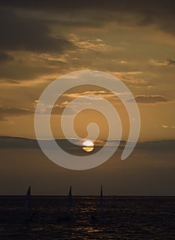 Sailing boats at the sunset photo